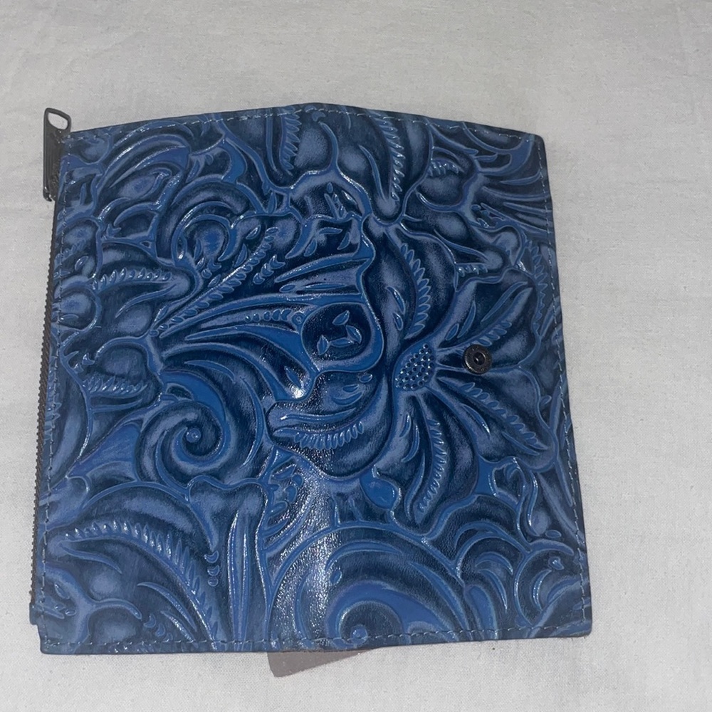 Blue tooled leather Nazari wallet by Patricia Nash.